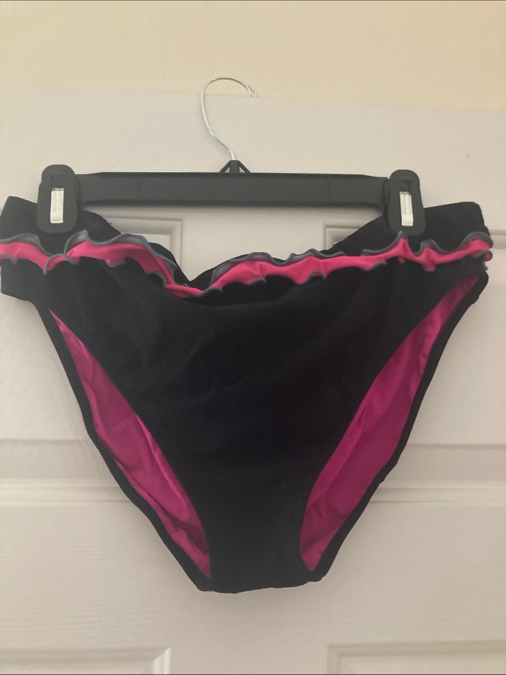 Profile swimwear with black and bright pink ruffle detail